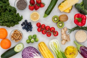 an assortment of colorful Fruits and Vegetables and a white background