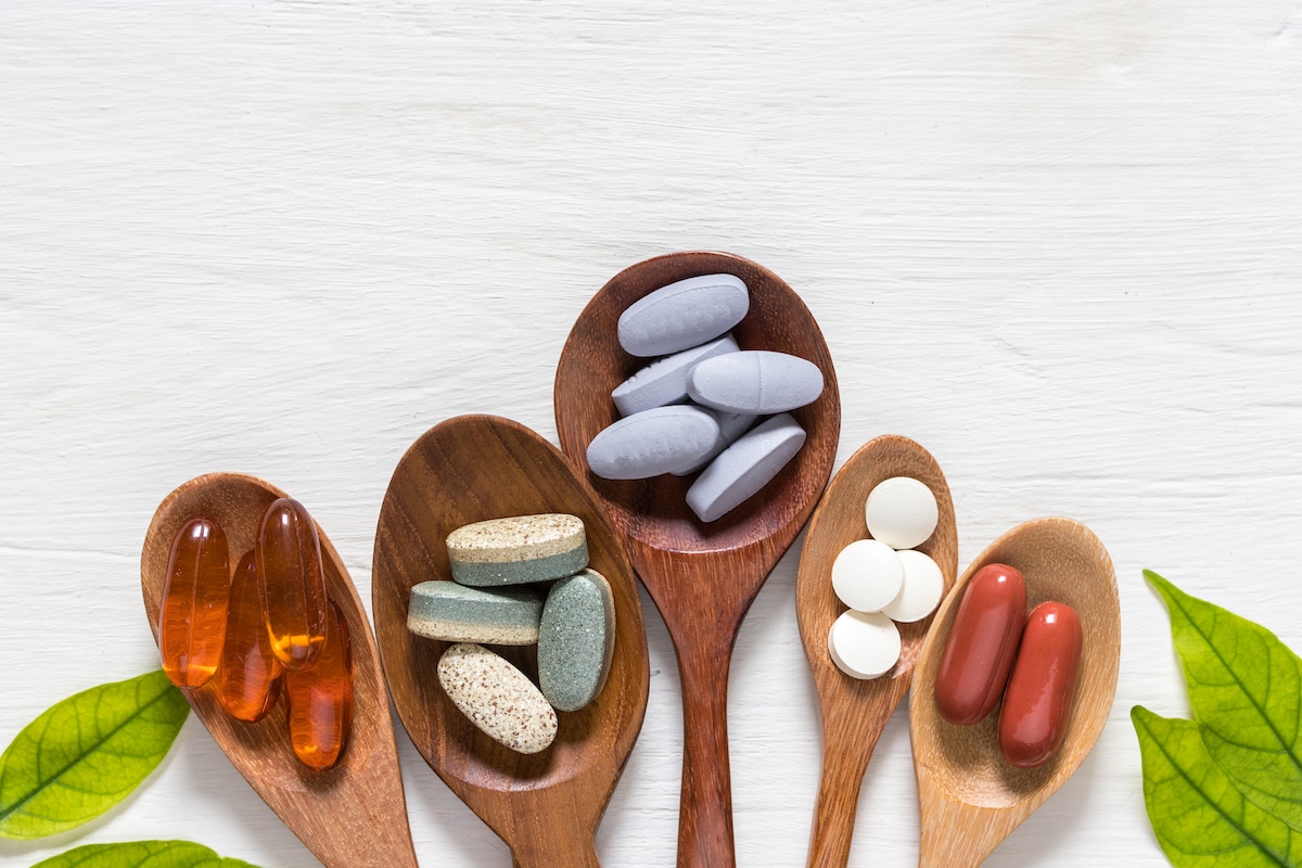 Image of supplements for leaky gut in spoons on a white background.